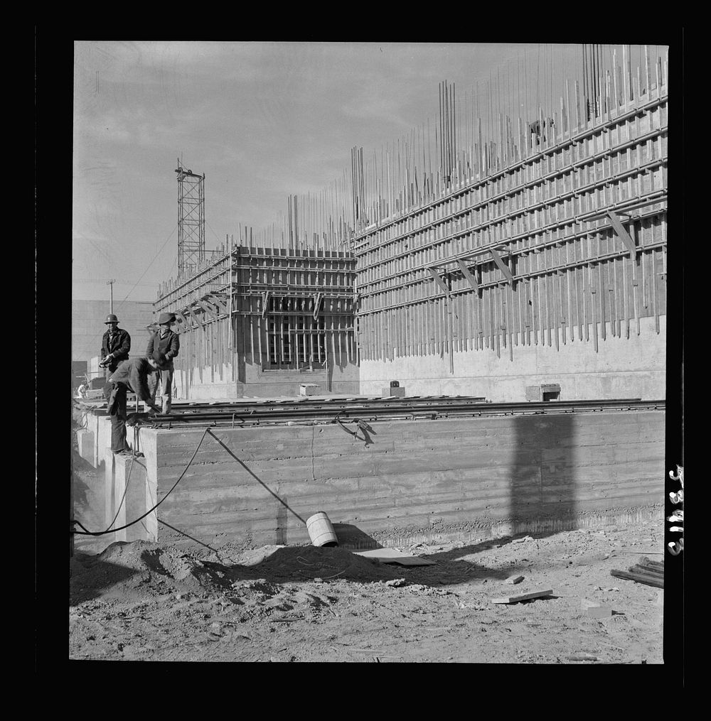 [Untitled photo, possibly related to: Las Vegas, Nevada. Helmeted welders busy in their part in the completion of the Basic…