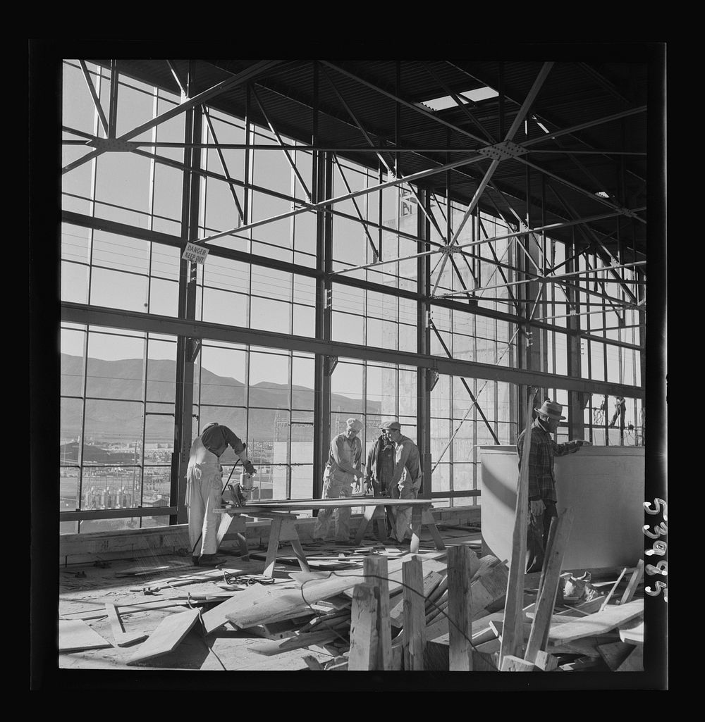 [Untitled photo, possibly related to: Las Vegas, Nevada. Workmen busy with woodwork inside the steel structure of one of the…