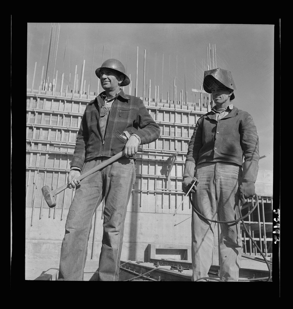 [Untitled photo, possibly related to: Las Vegas, Nevada. Helmeted welders busy in their part in the completion of the Basic…
