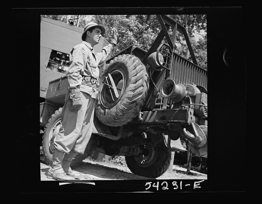 [Untitled photo, possibly related to: Fort Belvoir, Virginia. A soldier standing beside a truck with a mounted crane on it].…