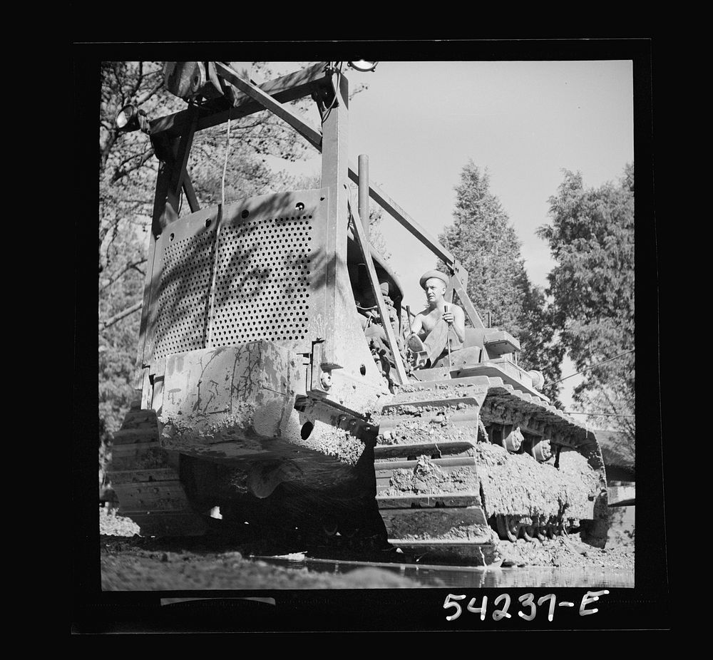 [Untitled photo, possibly related to: Fort Belvoir, Virginia. A soldier operating a heavy duty tractor]. Sourced from the…
