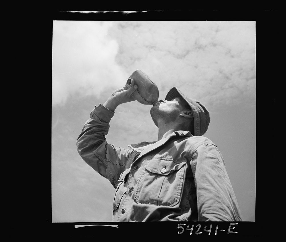 Fort Belvoir, Virginia. A soldier drinking from a G.I. water canteen. Sourced from the Library of Congress.