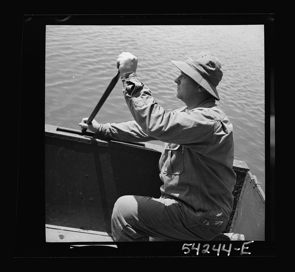 Fort Belvoir, Virginia. A soldier of the United States Army Engineer Corps paddling a barge. Sourced from the Library of…