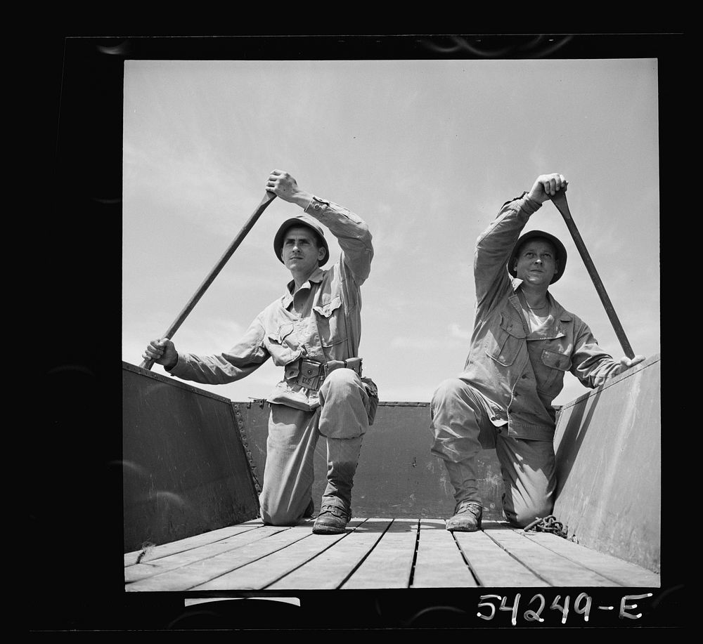 Fort Belvoir, Virginia. Two soldiers of the United States Army Engineer Corps paddling a barge. Sourced from the Library of…