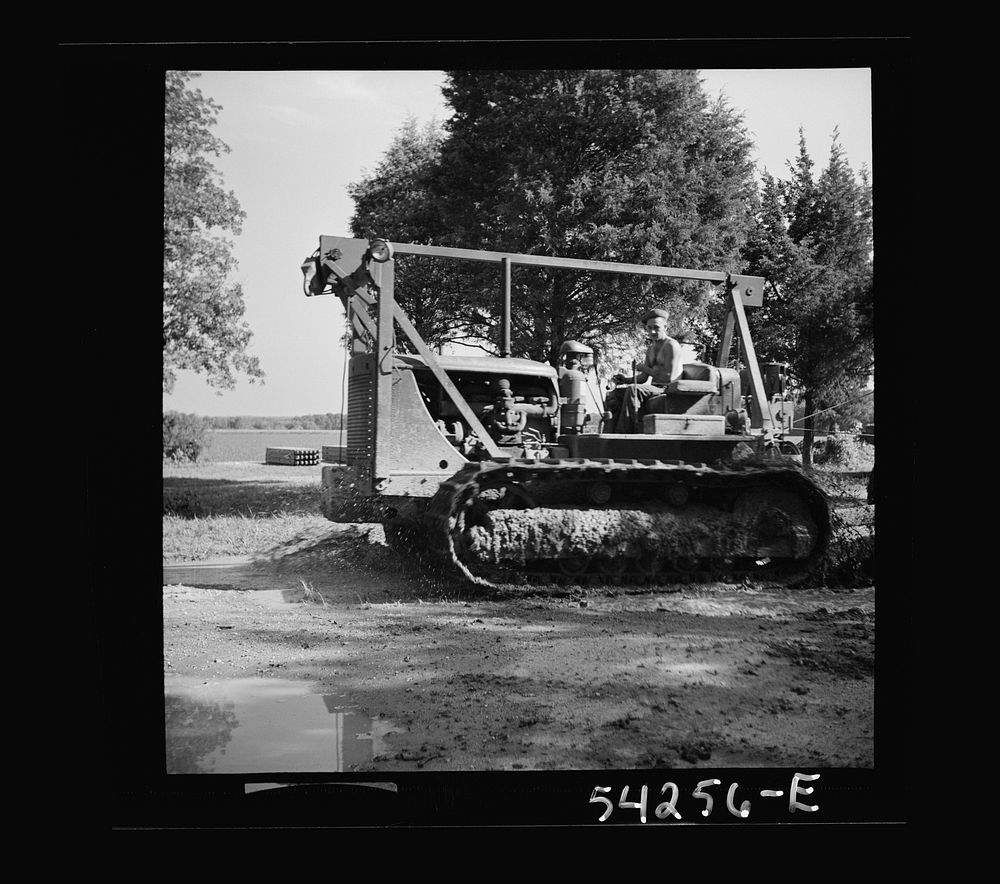 [Untitled photo, possibly related to: Fort Blvoir, Virginia. A soldier operating a heavy duty tractor]. Sourced from the…