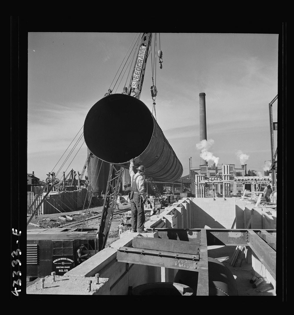 Columbia Steel Company at Geneva, Utah. Setting a pipe with a derrick during the construction of a new steel mill which will…
