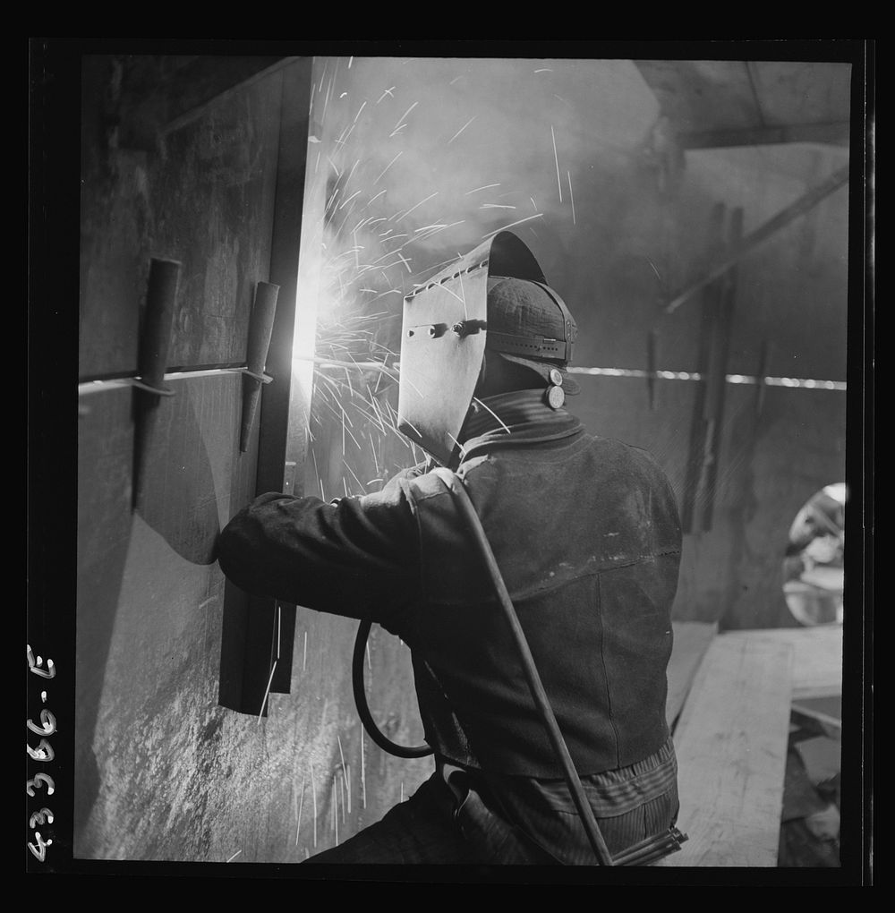 Columbia Steel Company at Geneva, Utah. An electric arc welder helping in the construction of a new steel mill which will…