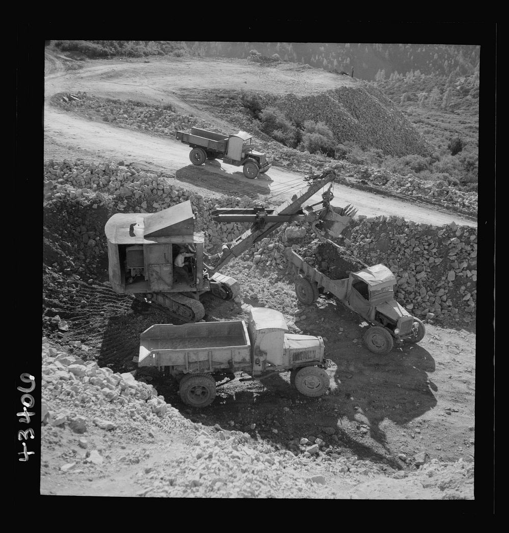 New Idria, California. Trucks, shovel, and crane used in loading cinnabar, an ore containing mercury, at an open-cut mine of…