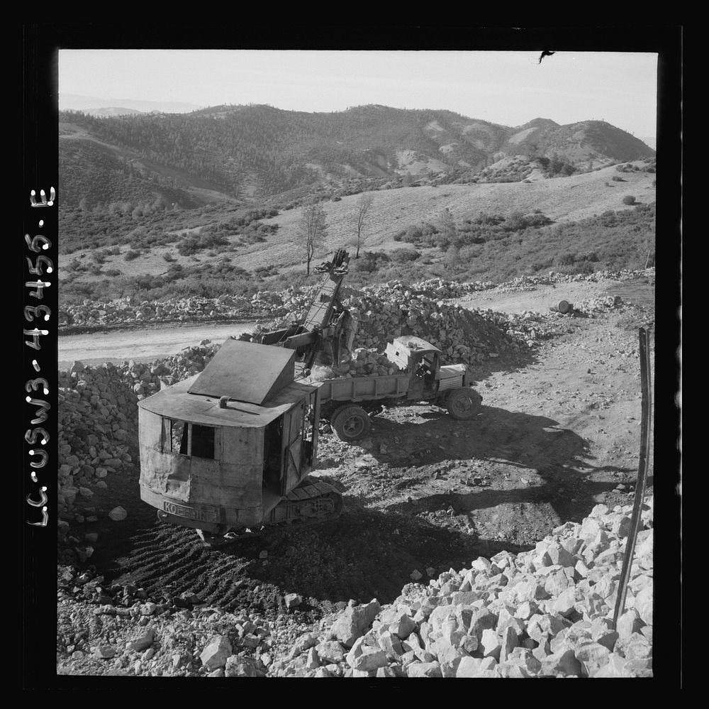 [Untitled photo, possibly related to: New Idria, California. Trucks, shovel, and crane used in loading cinnabar, an ore…