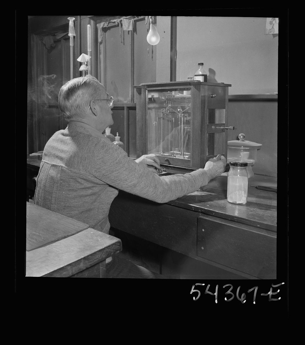 [Untitled photo, possibly related to: Kingman (vicinity), Arizona. Mr. Relling, in the laboratory, analyzing tungsten ore…