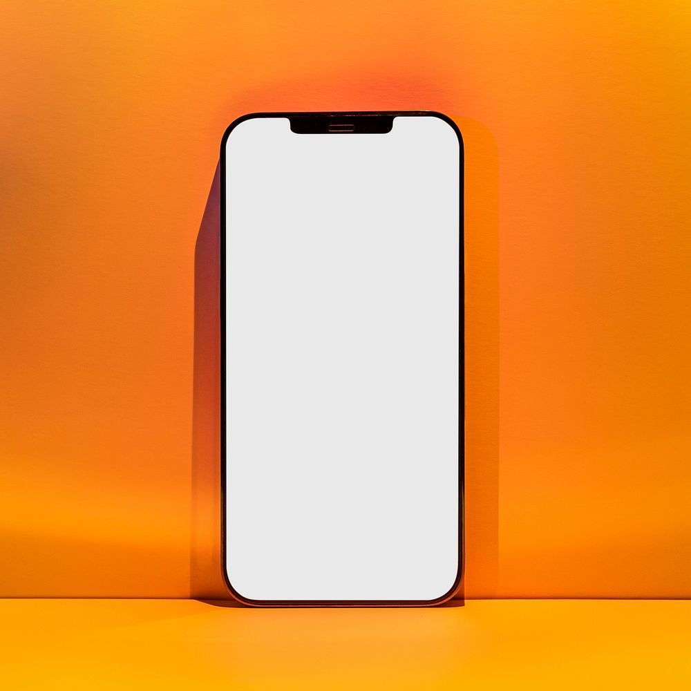 Blank mobile phone screen with orange sunset projector lamp