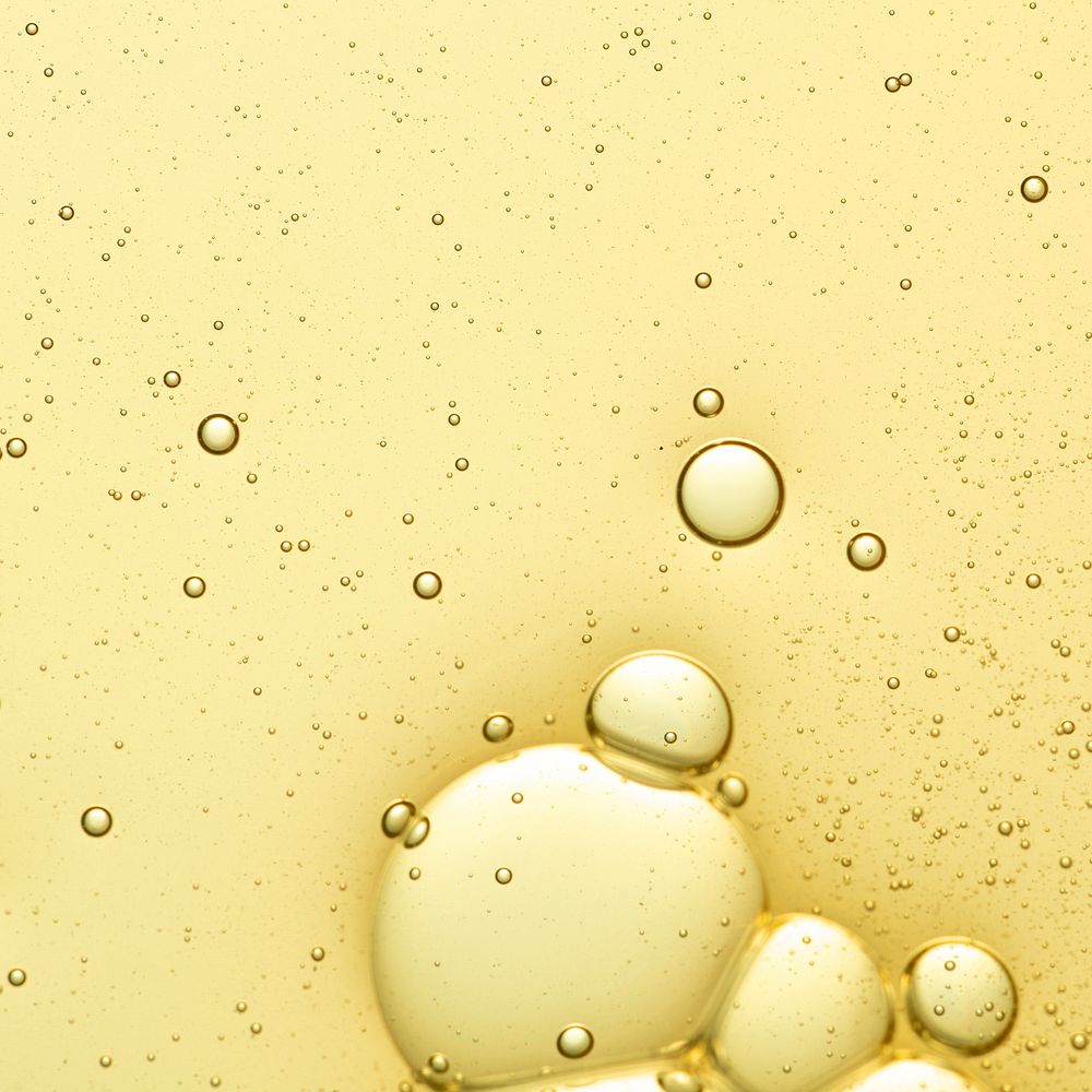 Yellow background, oil bubble in water