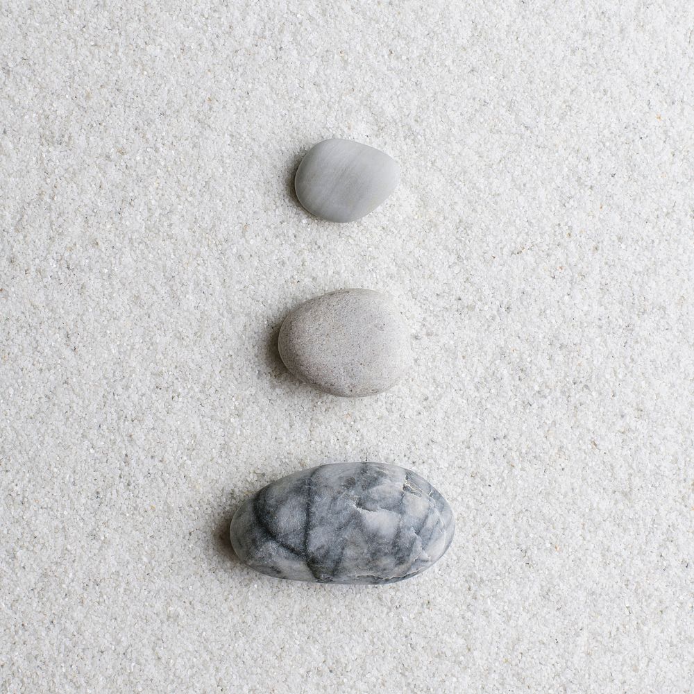 Marble zen stones stacked on white background in stability concept