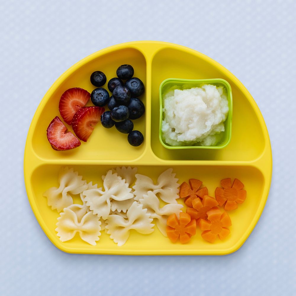 Baby finger food healthy meal on a yellow plate