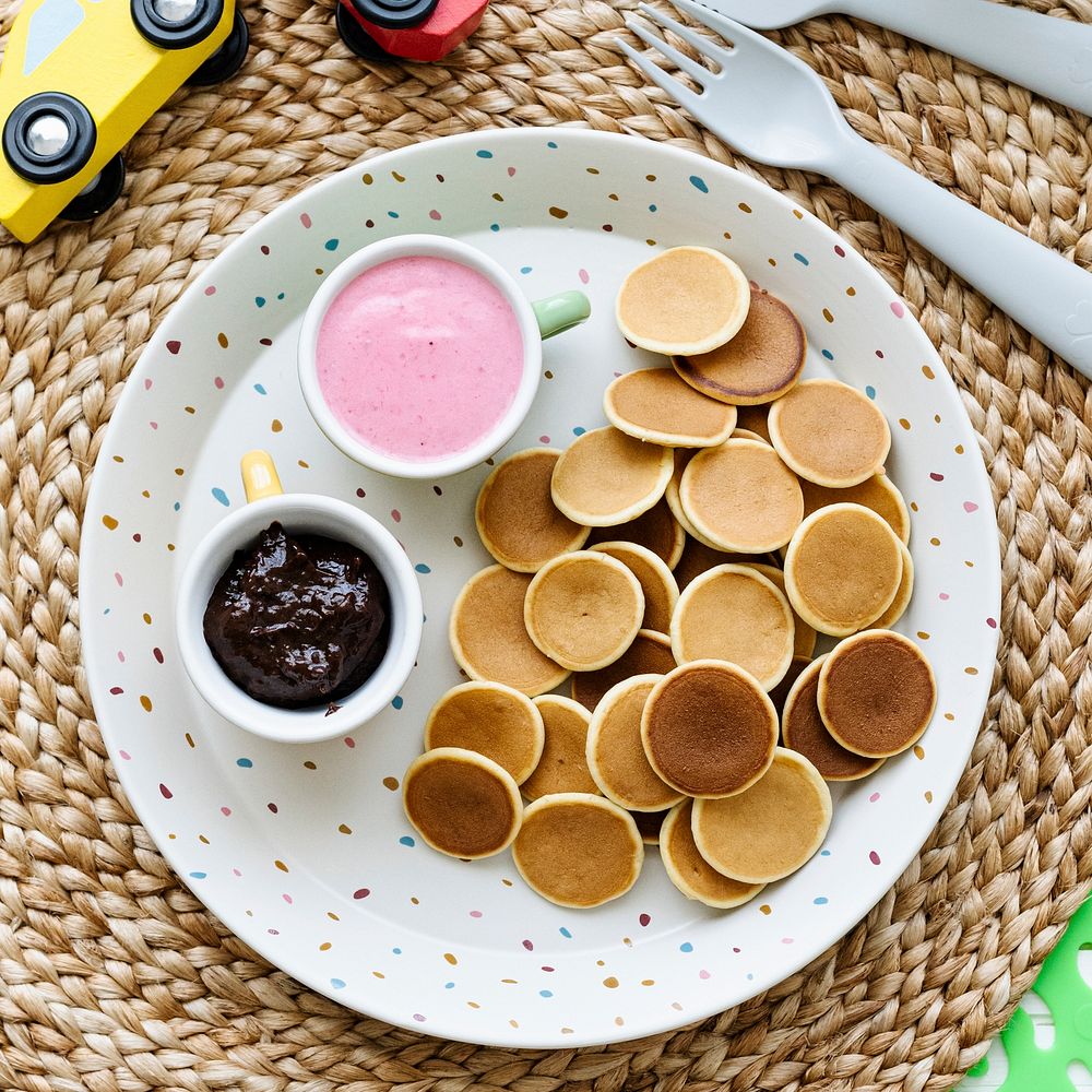 Mini pancakes kids breakfast treat with chocolate spread and strawberry yogurt