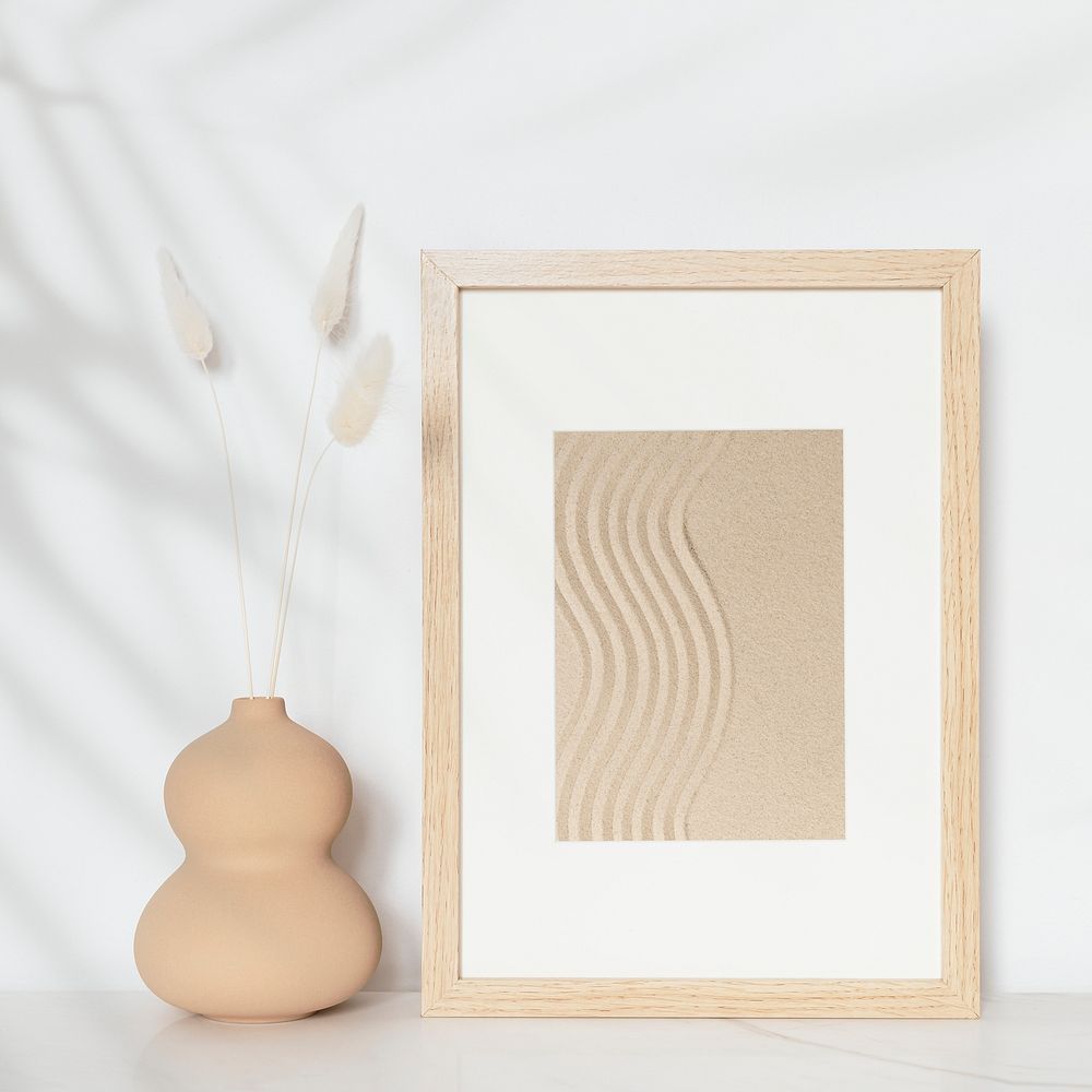Wooden picture frame with zen sand photo on the wall interior concept