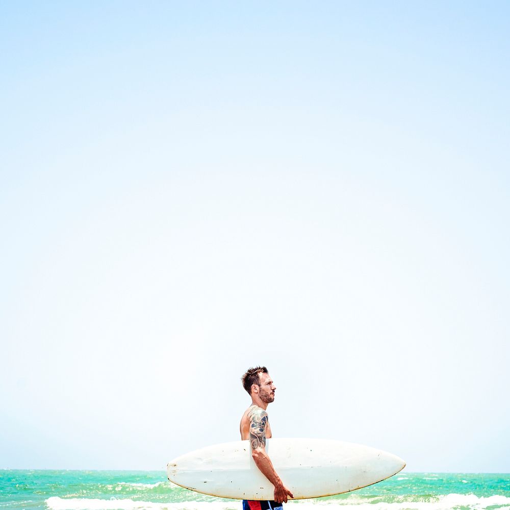 Summer background male surfer, bright blue tone filter