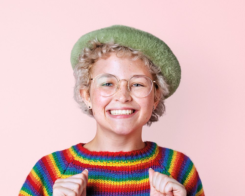Artsy teenage girl, happy face portrait in rainbow sweater