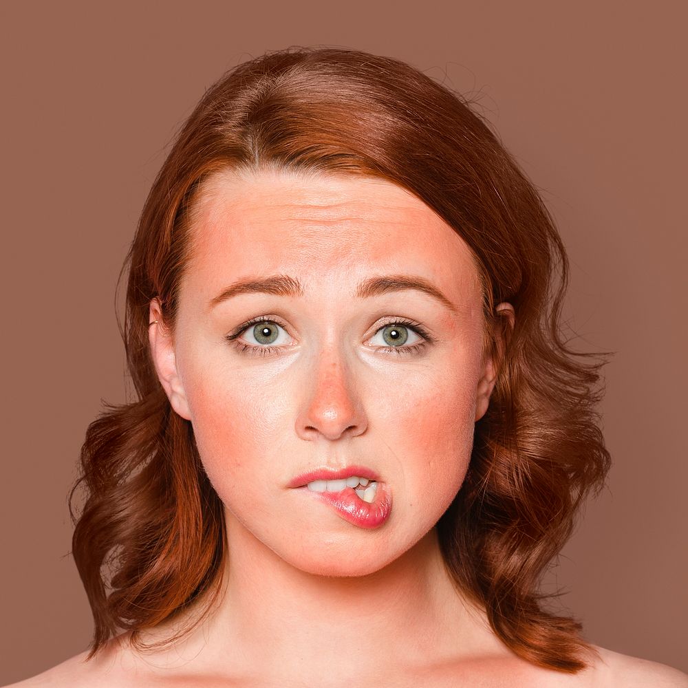 Sunburnt woman face portrait, biting her lips
