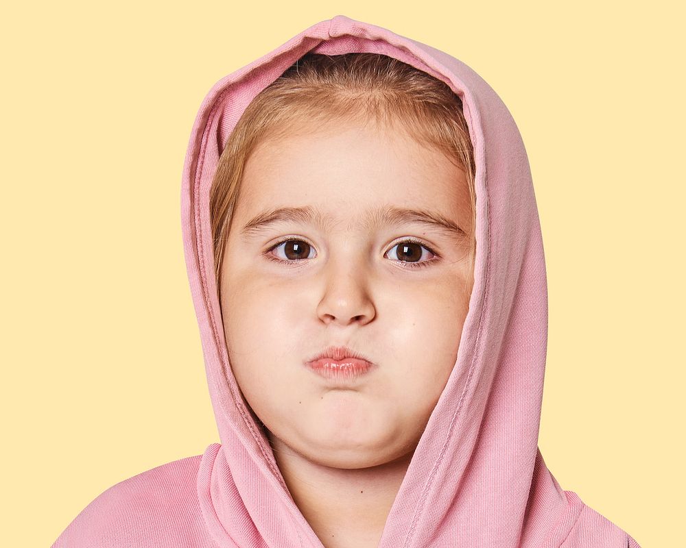 Little girl pouting face portrait, close up psd