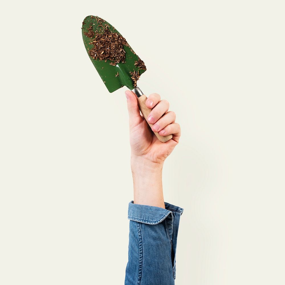 Hand mockup psd holding green shovel gardening tool