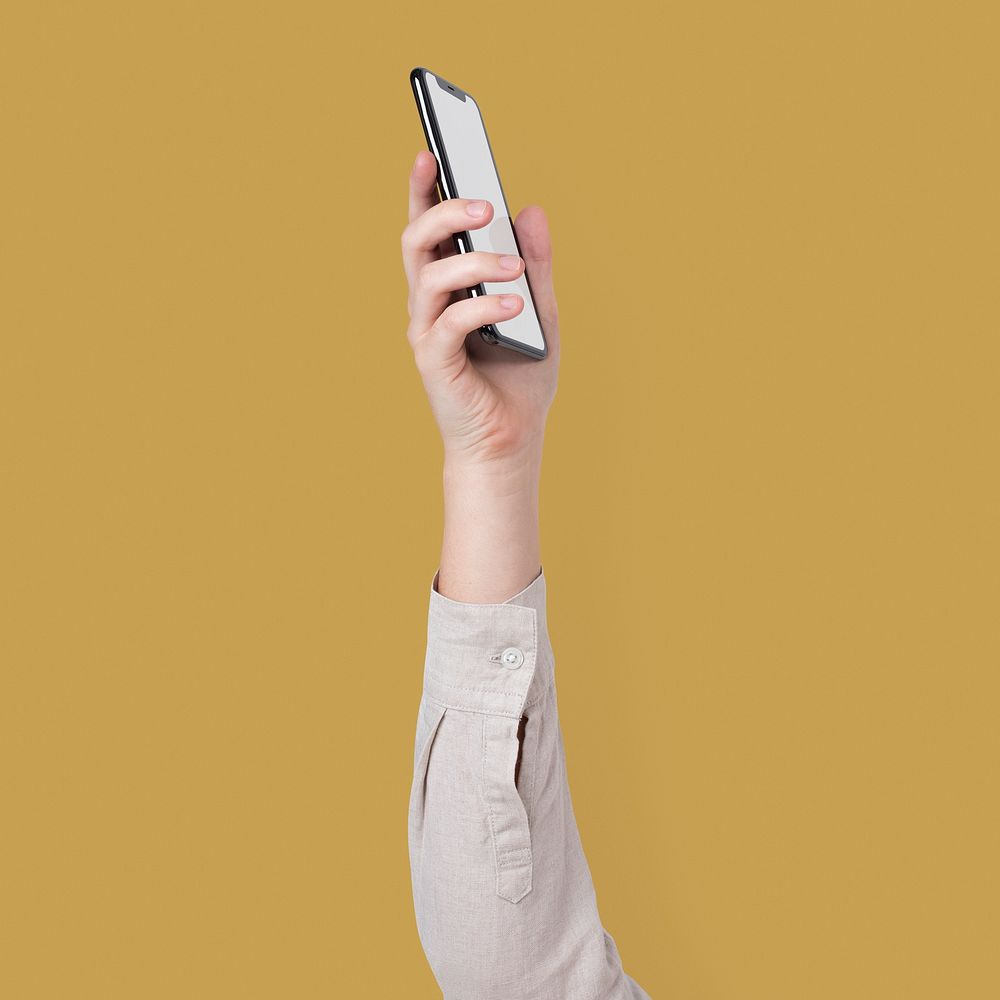 Blank smartphone screen isolated in studio with hand raised