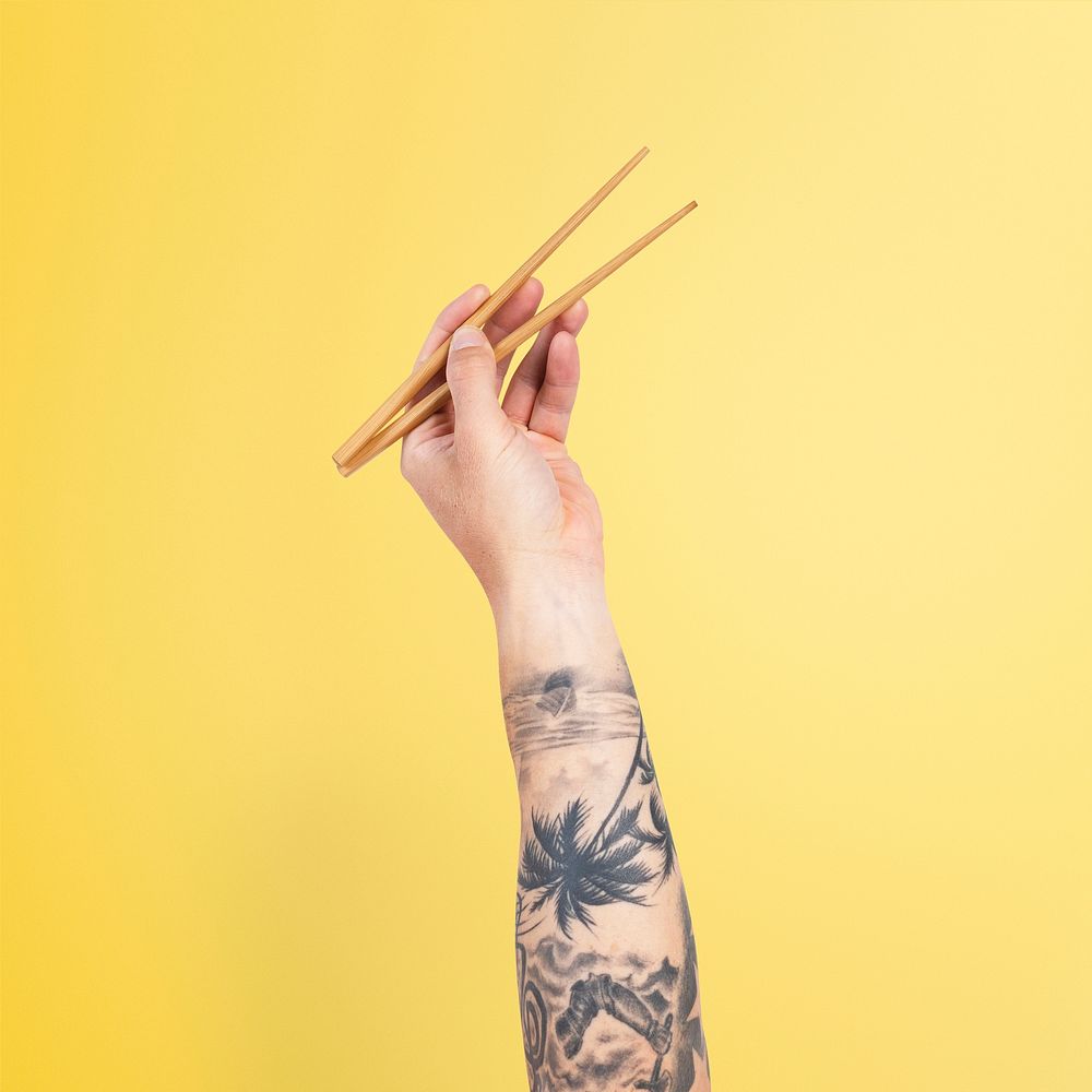 Hand holding chopsticks for food concept