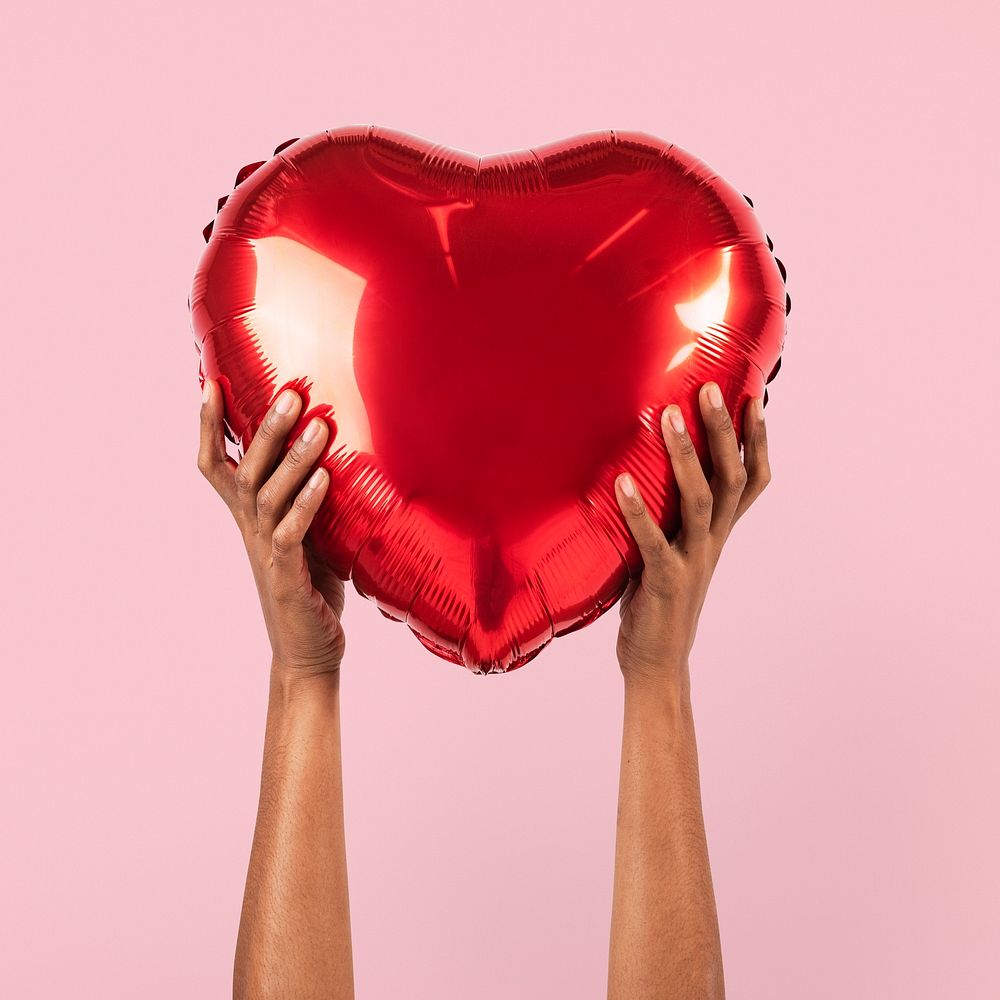 Valentines heart balloon held by a person