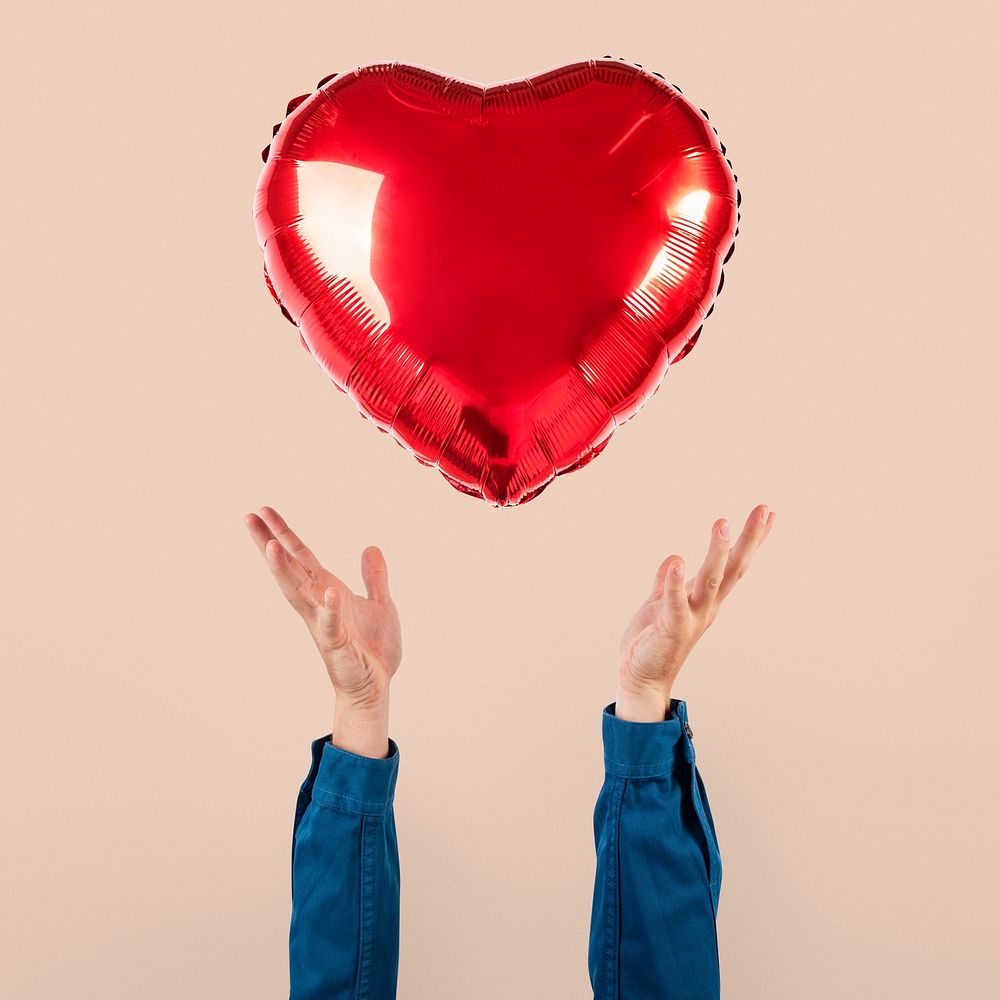 Valentines heart balloon held by a person