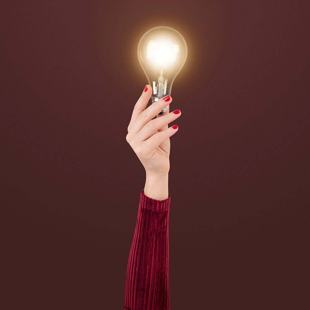 Light bulb creative business idea symbol held by a hand