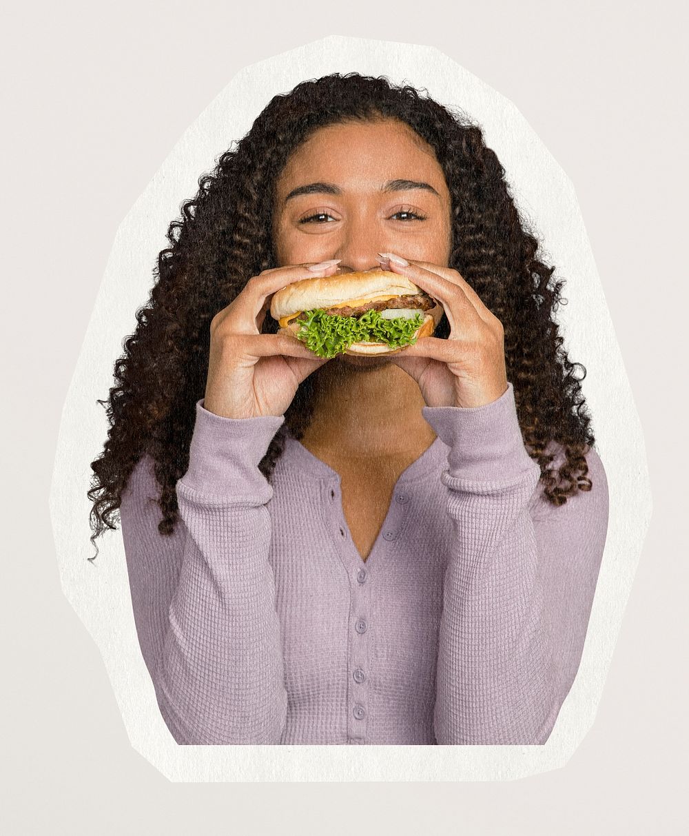 Happy woman eating a hamburger