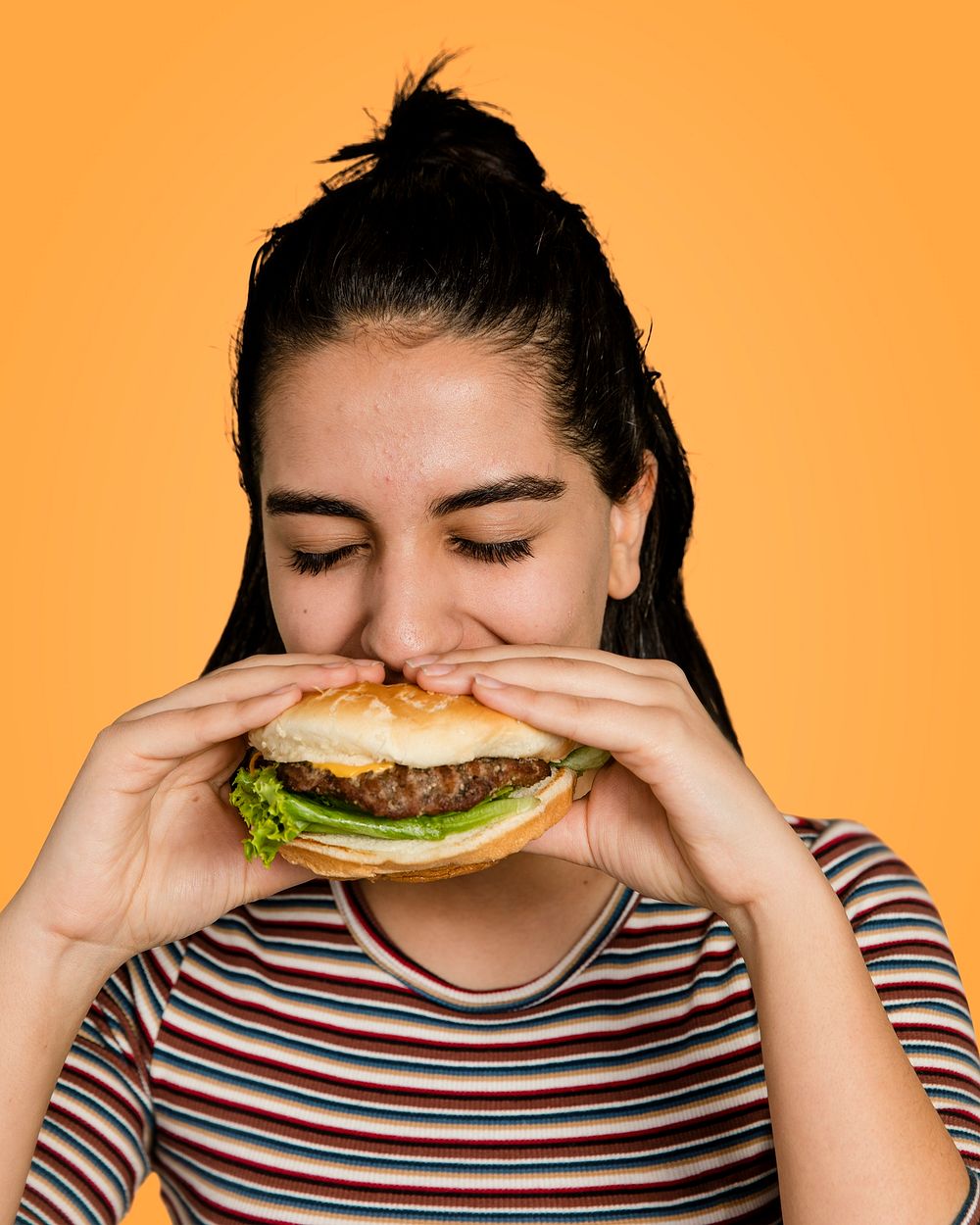 Hamburger lunch, hungry girl eating a burger