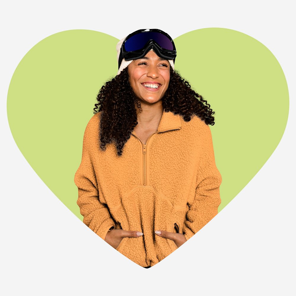 Happy woman with ski goggles, green heart shape badge