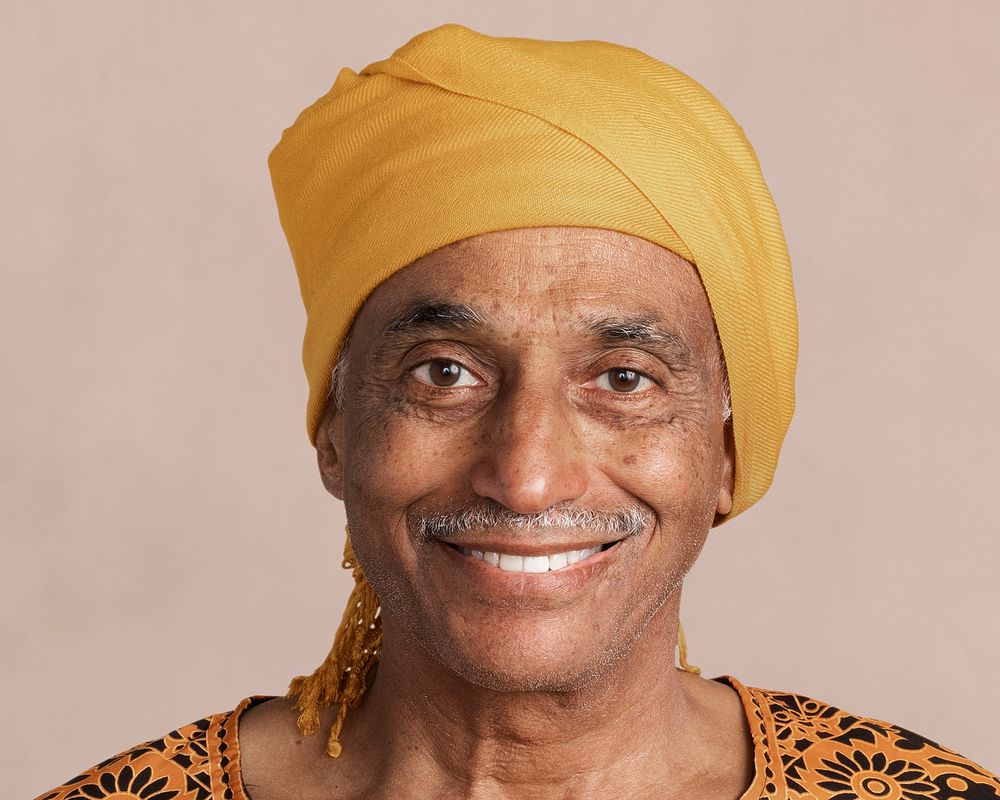 Happy Indian senior man, wearing a yellow turban