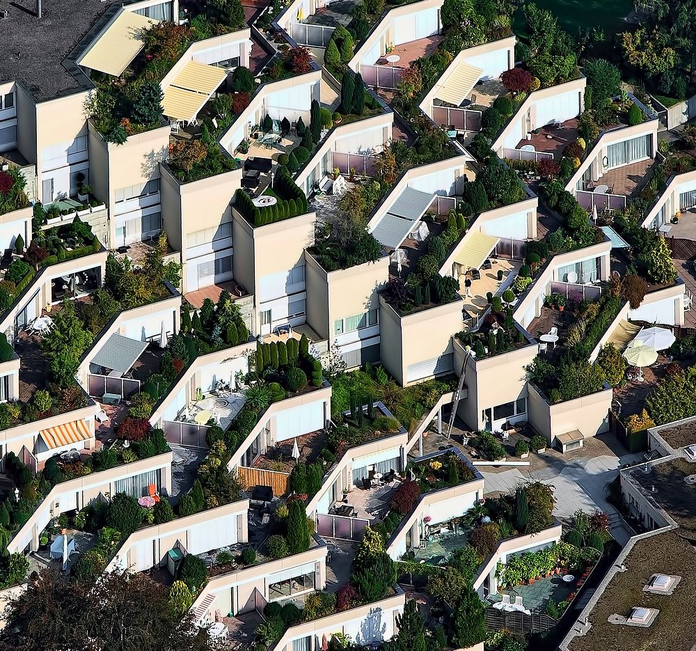 A drone shot of a housing estate with beautiful gardens on building roofs. Original public domain image from Wikimedia…