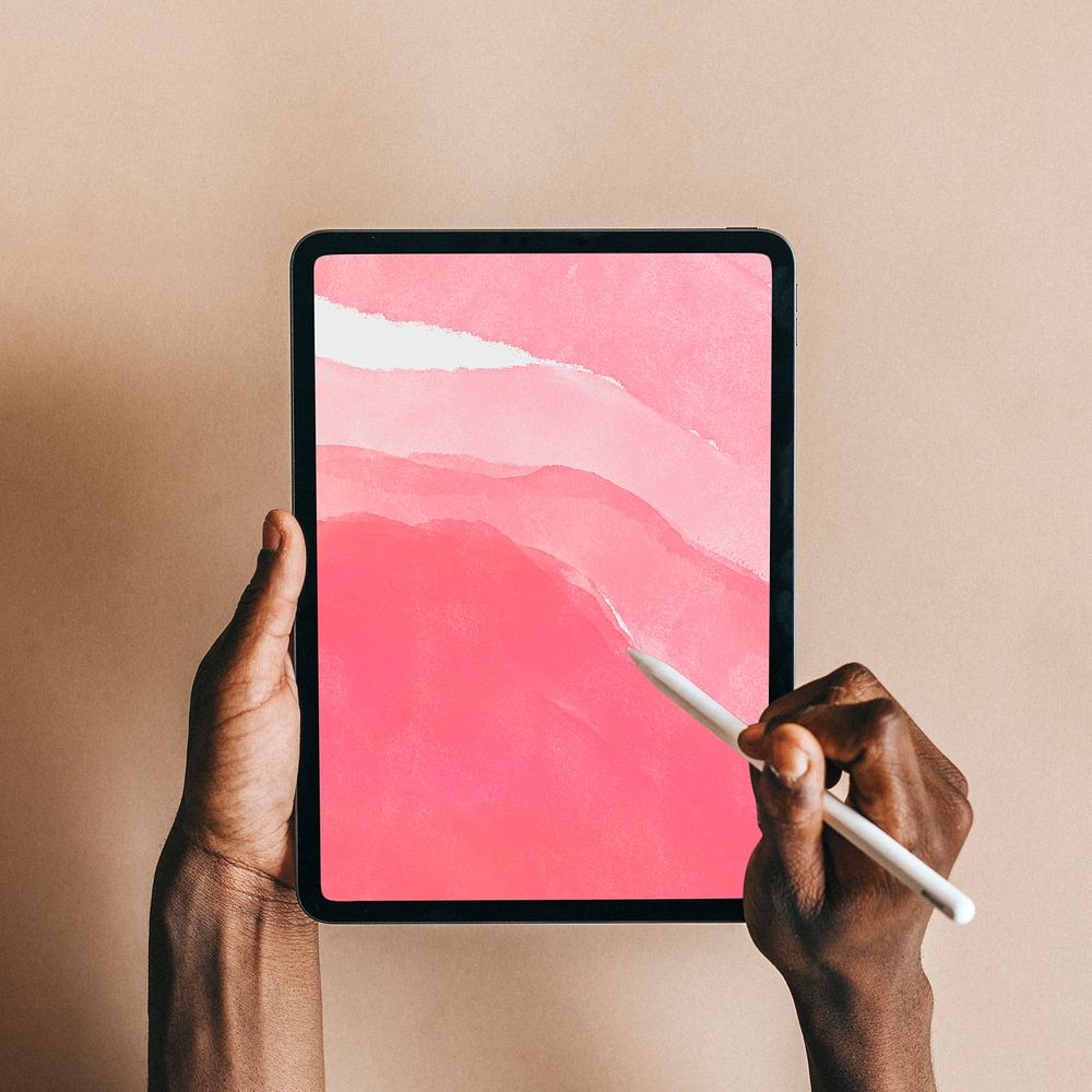 Man using a digital tablet with watercolor wallpaper