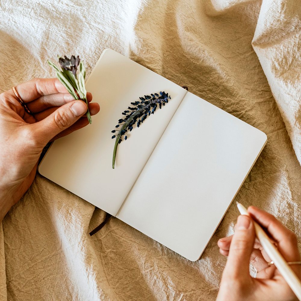 Writing journal with pencil and flowers