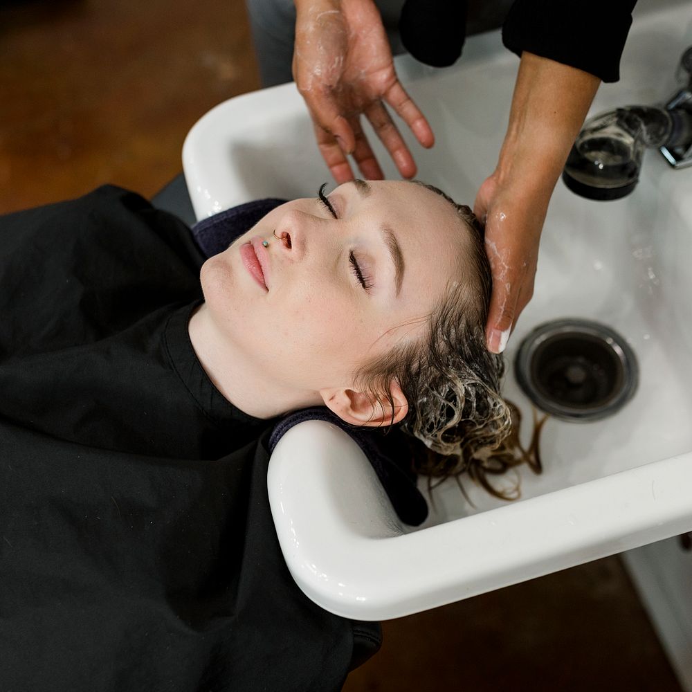 Woman getting a hair wash at a beauty salon 