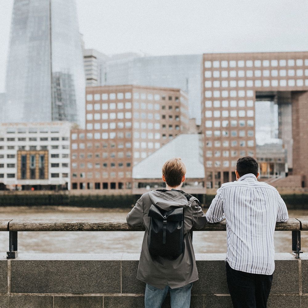 Traveler friends admiring London skyline from a bridge 