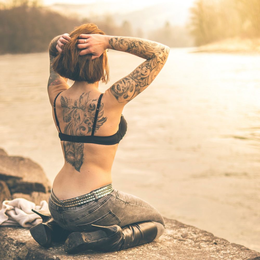 Woman with back tattoo. Free public domain CC0 photo.