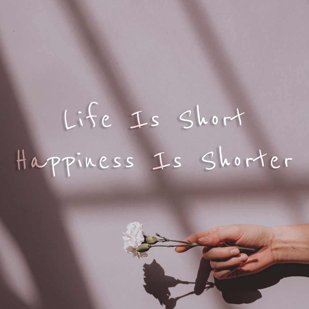 Life is short happiness is shorter quote on a natural light background