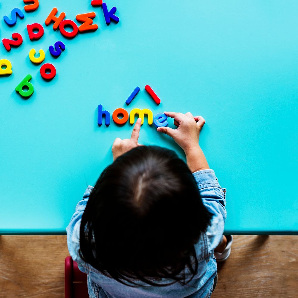 Kid playing with letters at home