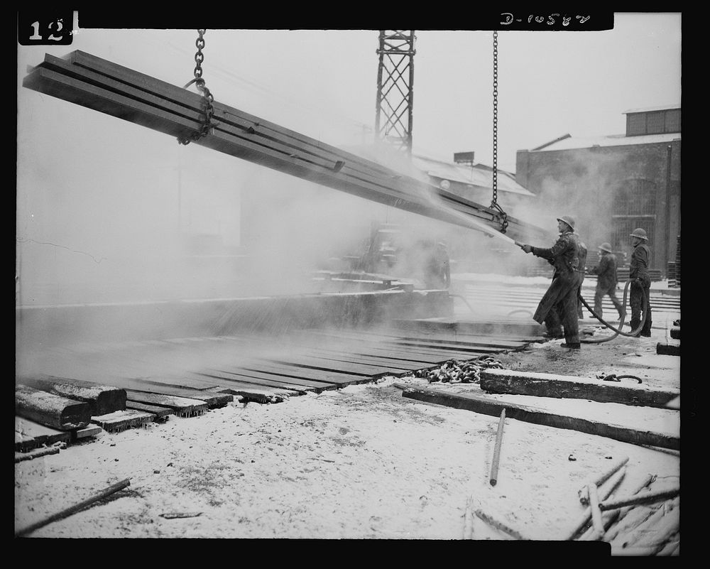 Denver, Colorado. Workers giving ship steel a thorough rinsing after it has been "pickled" in the highest steel "pickling"…