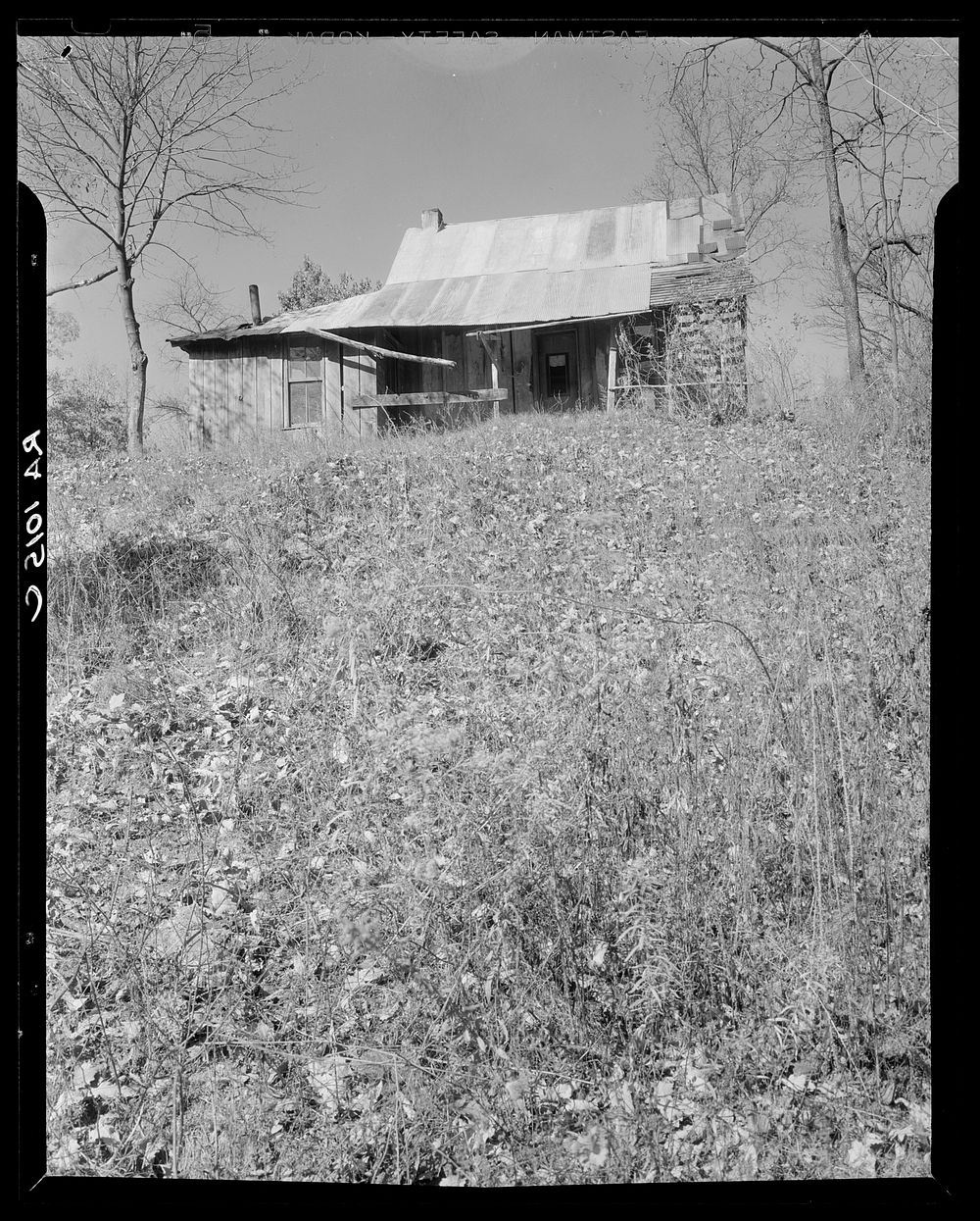 Abandoned house of a resettled farmer who is now moved into a neighboring county. Brown County, Indiana. Sourced from the…