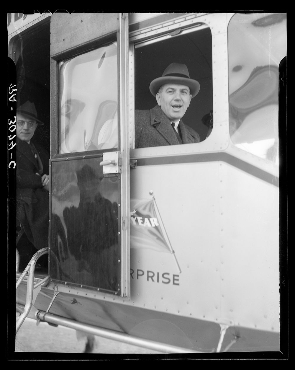 Administrator Tugwell at window of blimp before taking off. Sourced from the Library of Congress.
