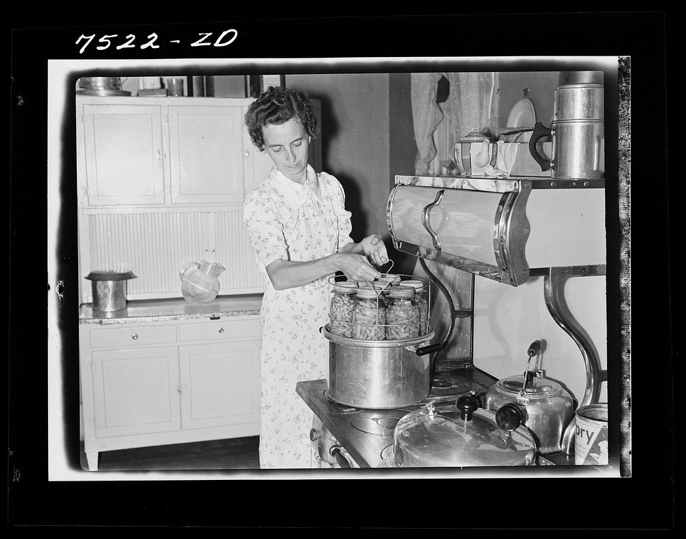 Mrs. Thornton, wife of Farm Security Administration borrower, canning vegetables with pressure cooker. Story County, Iowa.…