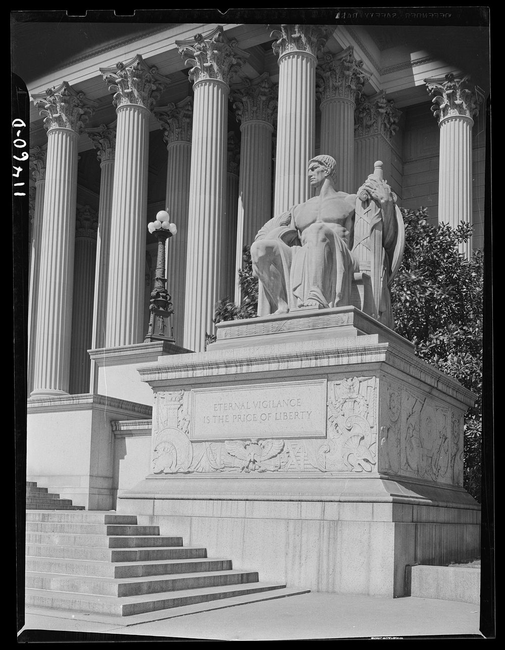 Washington, D.C. Statue on the right of the main entrance to the National Archives of the United States bears the…