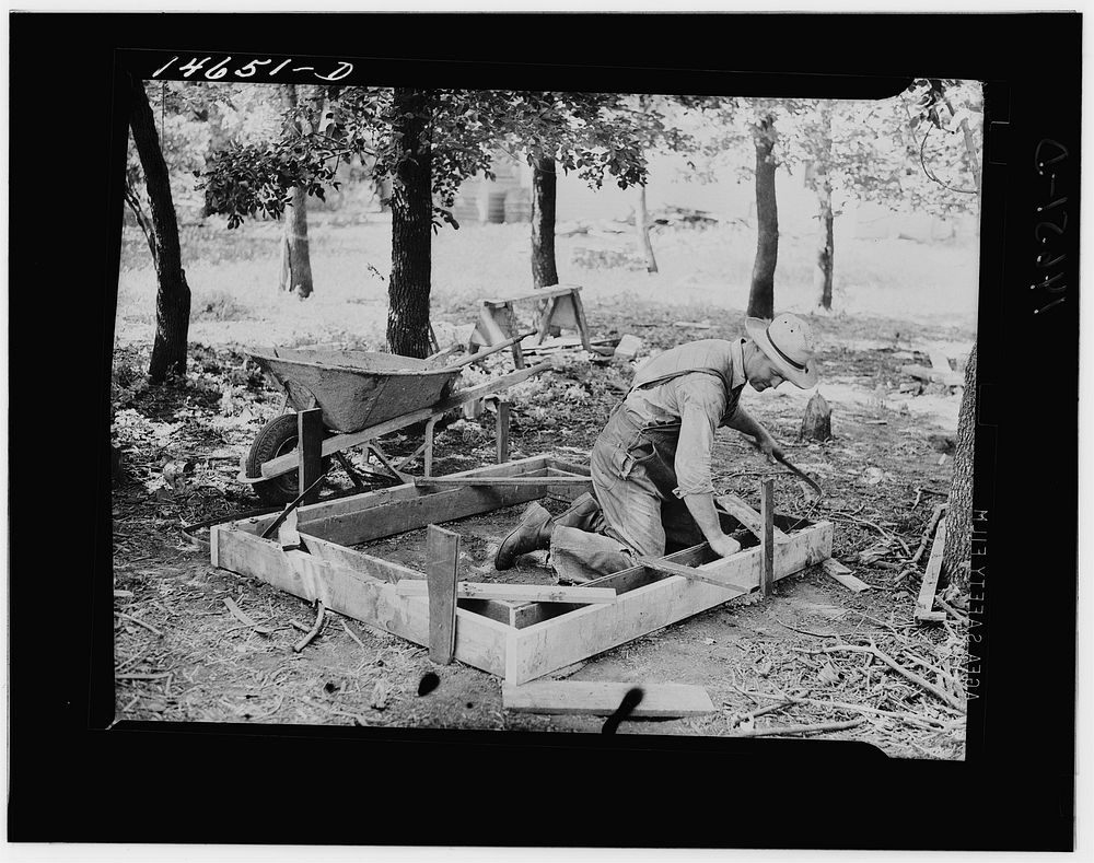 Setting the form for a concrete slab for a new privy. Minnesota. Sourced from the Library of Congress.