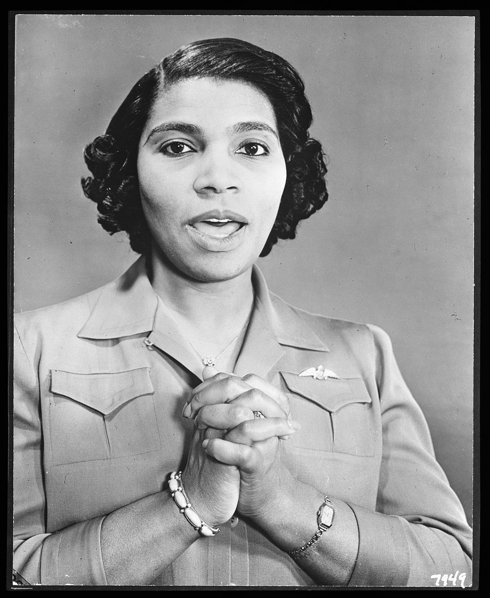 [Untitled photo shows: Marian Anderson, opera singer, singing with hands clasped and wearing a pin in the shape of the Royal…