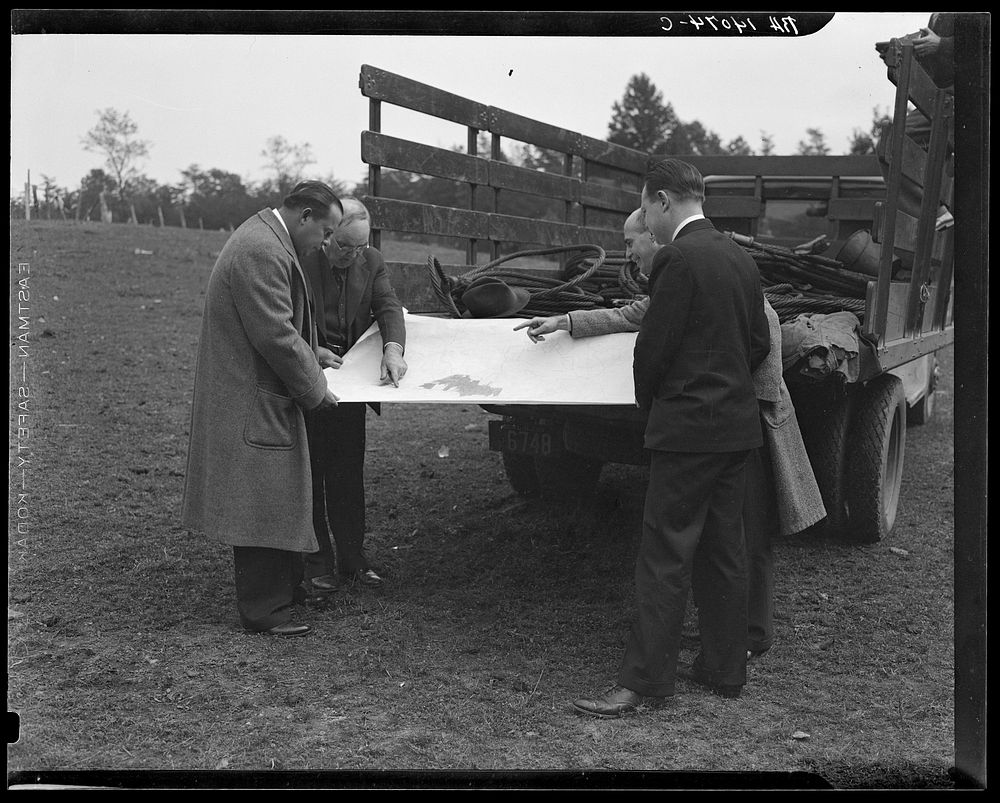 [Untitled photo, possibly related to: Officials examining plan of Greenbelt, Maryland]. Sourced from the Library of Congress.
